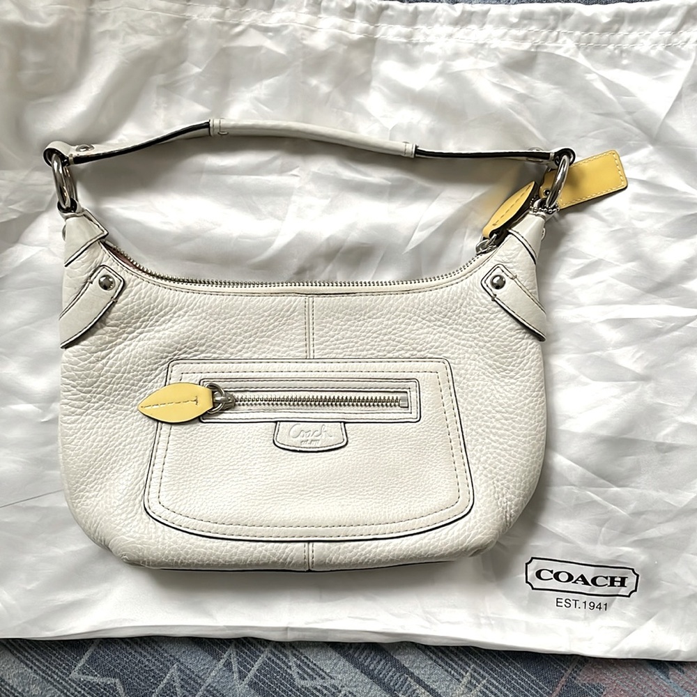 White Coach handbag with yellow leaf features. Pink interior. Very gently used.